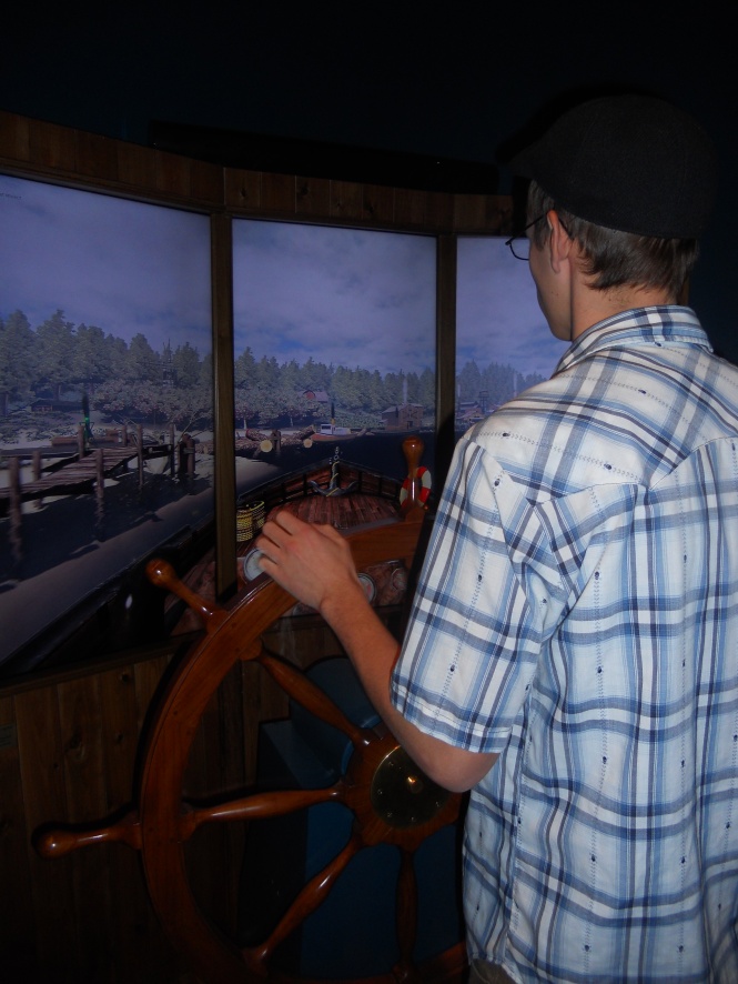 In the exhibit of Great Lakes Shipwrecks, Cameron played a cargo ship game--steerin' the boat
